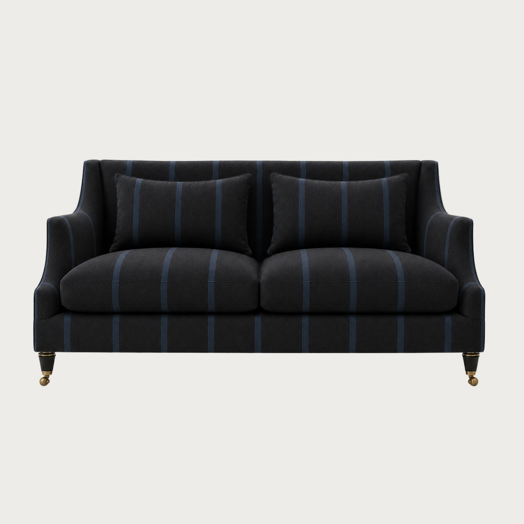 House of Ellory Clarington Sofa upholstered in charcoal grey pinstripe fabric with blue stripes, tailored cushions and traditional caster legs.