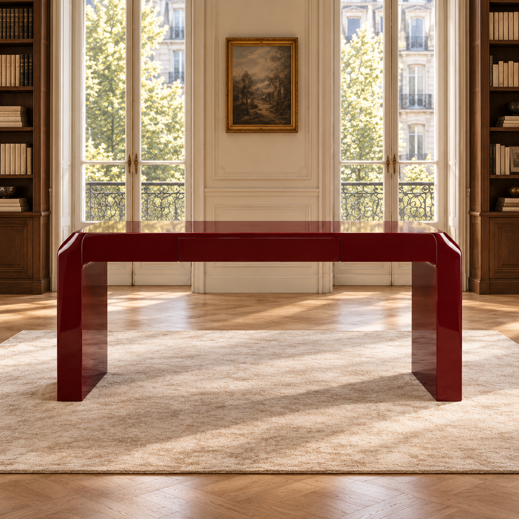 A glossy deep red rectangular console table with integrated legs, set in a bright, elegant room with a beige rug, wooden floors, and large windows.