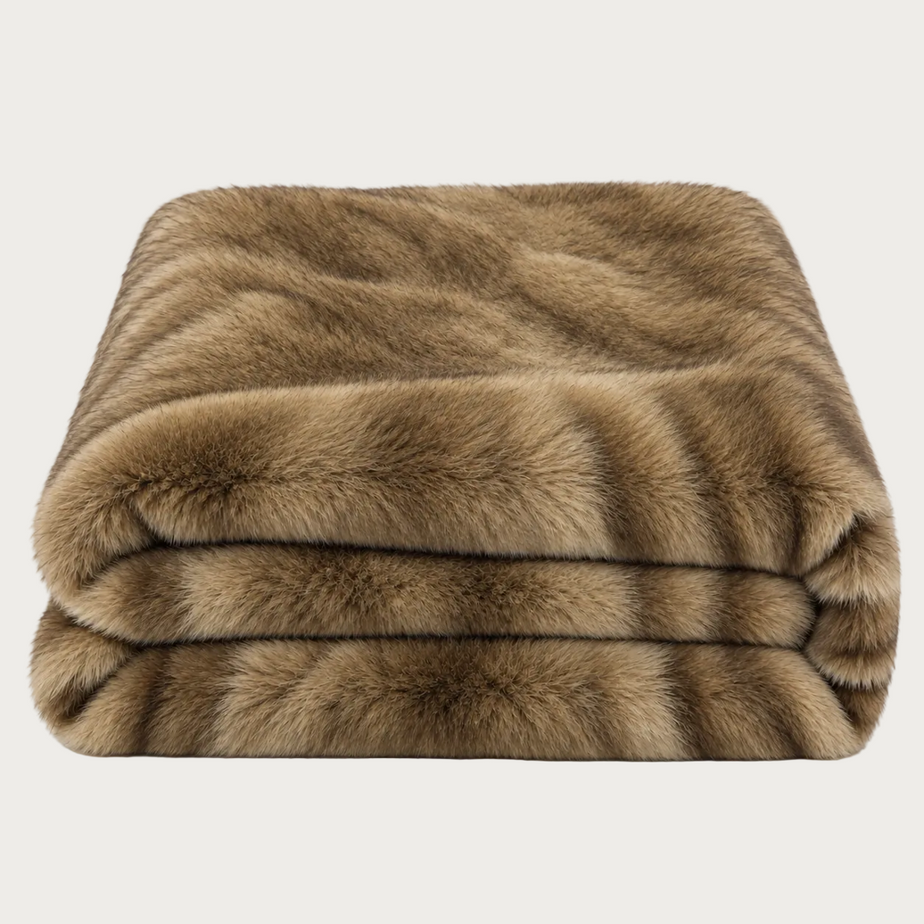 A folded faux fur throw blanket in a warm brown and tan colorway, shown against a plain white background.