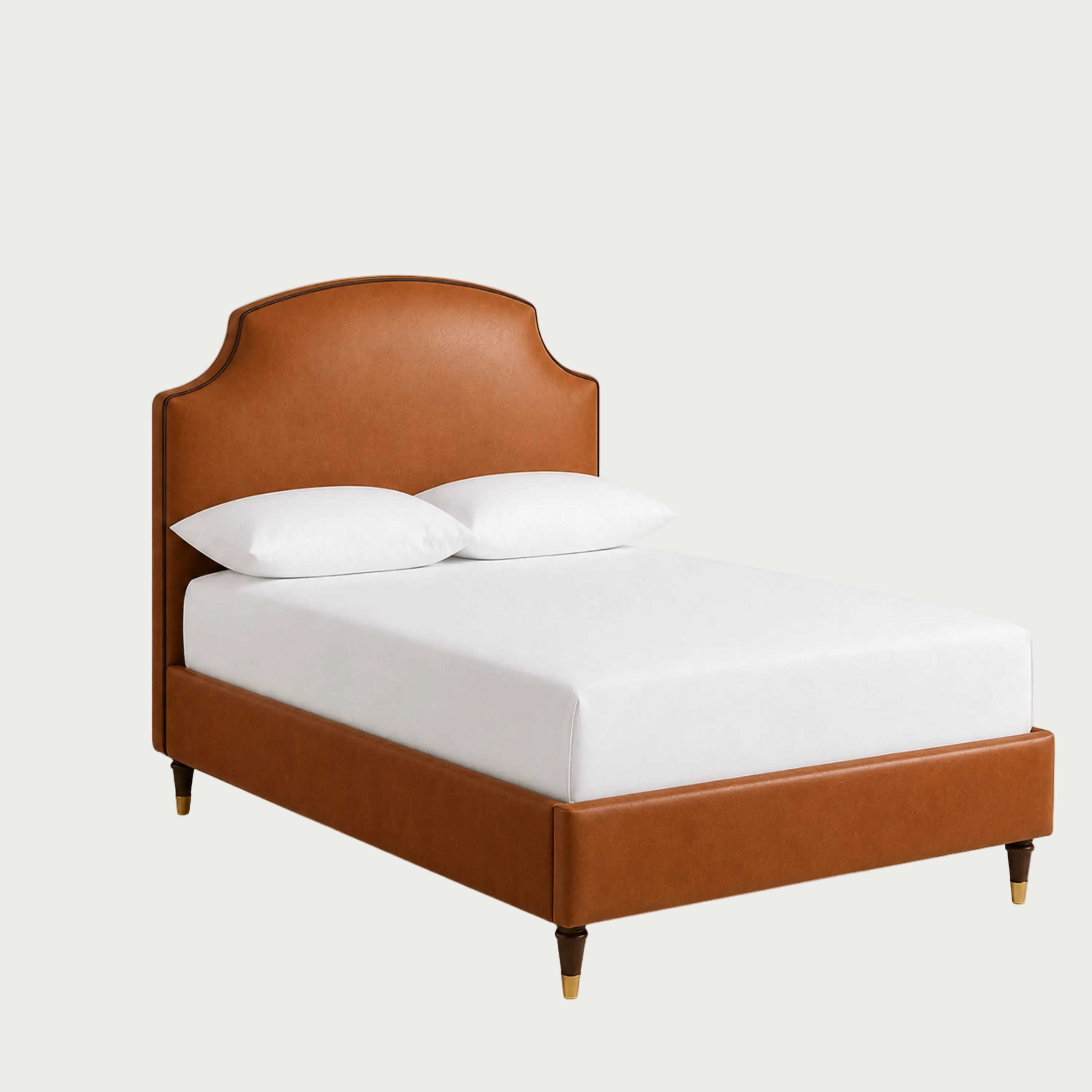 A modern upholstered bed frame in warm cognac brown leather, shown with a white mattress and two white pillows.