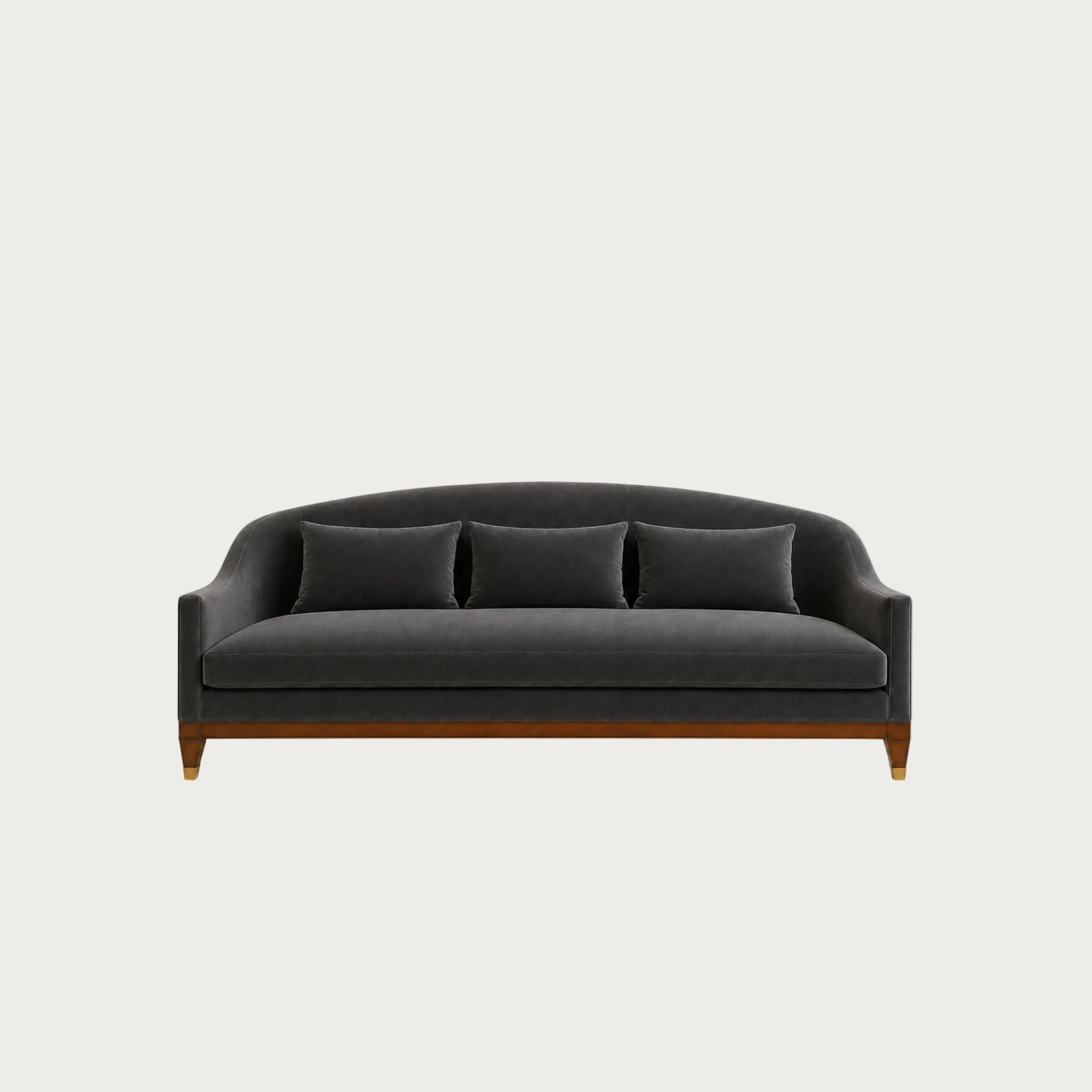 A modern three-seater sofa in dark charcoal gray velvet with three matching throw pillows and a medium-brown wooden frame, shown against a solid light gray background.
