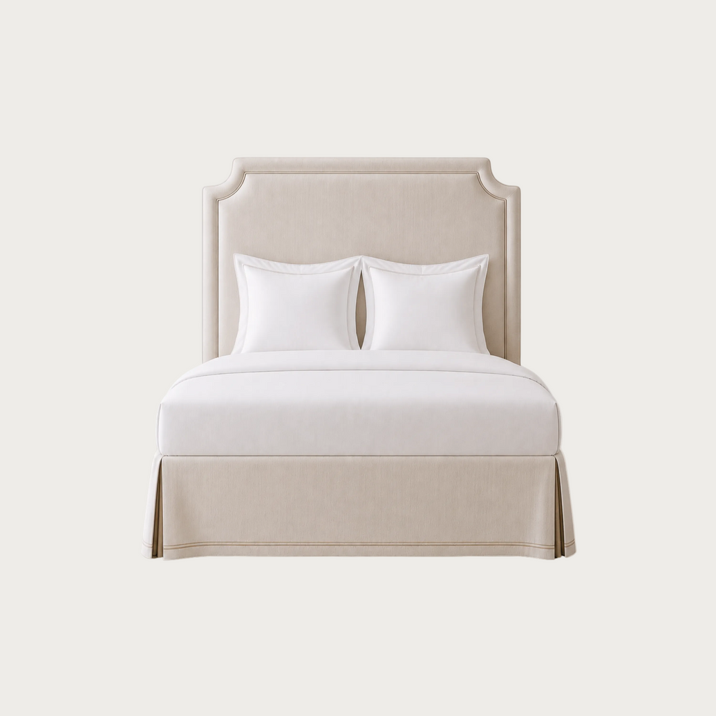 A tall upholstered headboard in a light warm beige fabric. House of Ellory custom-made.