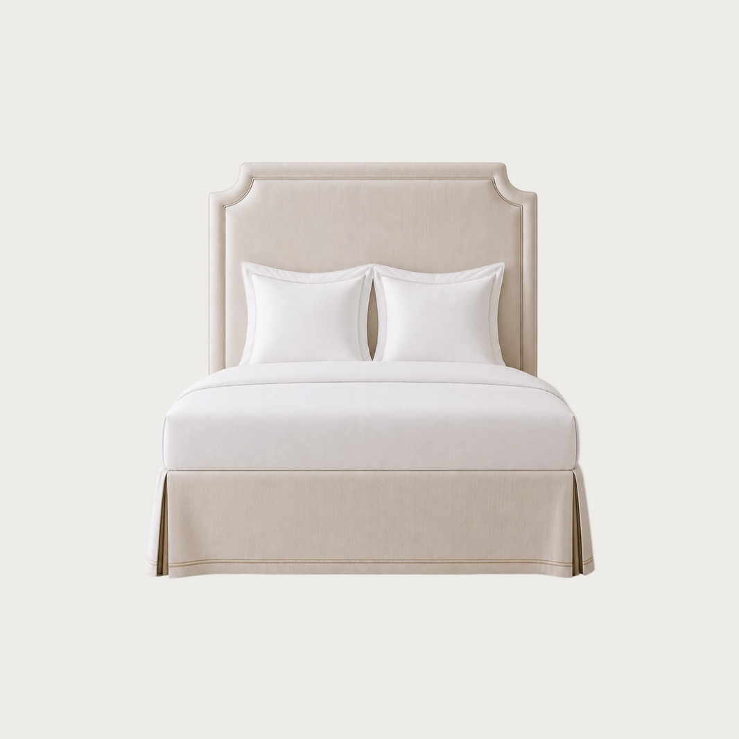A tall upholstered headboard in a light warm beige fabric. House of Ellory custom-made.