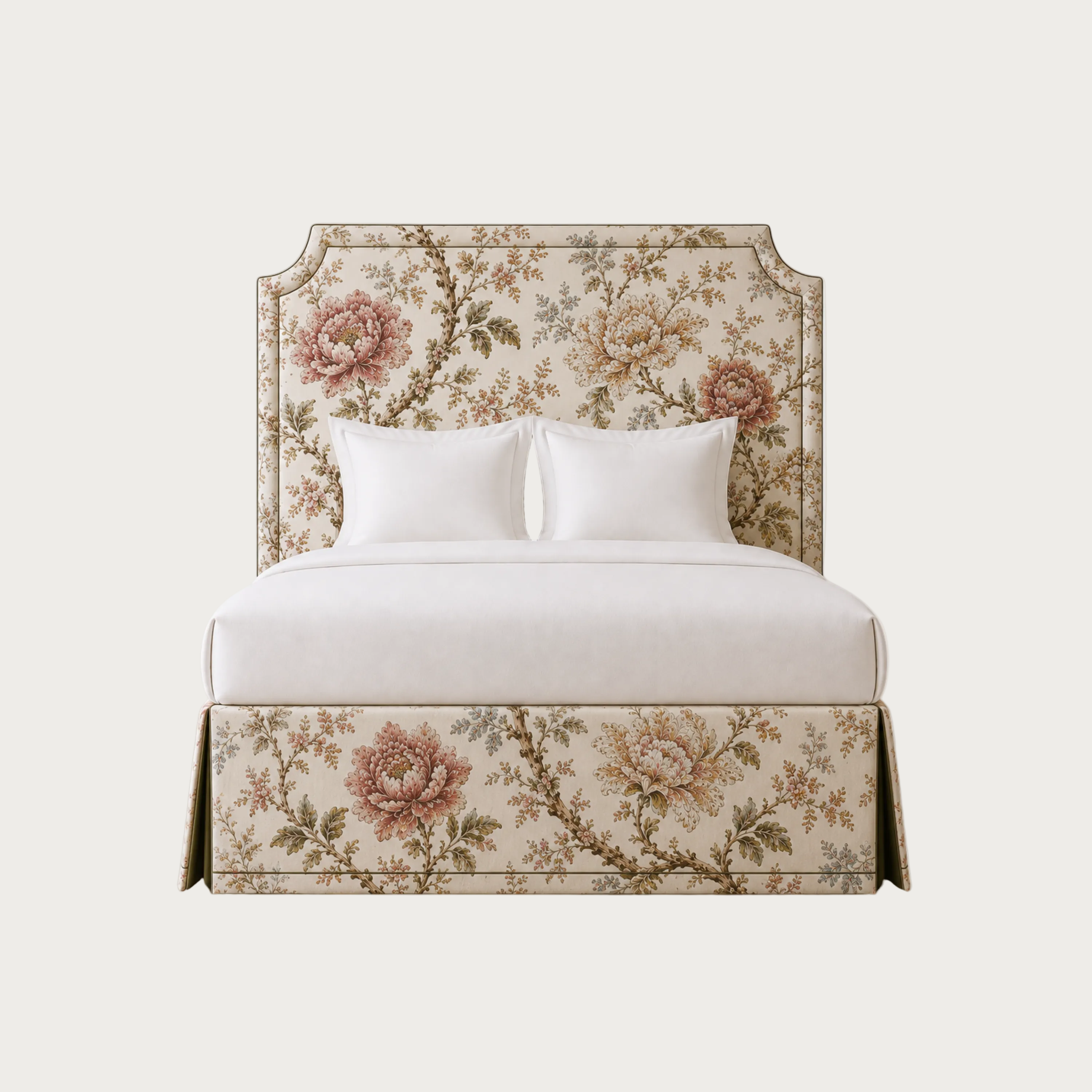 A bed with a tall upholstered headboard and skirted base, covered in a beige floral pattern with pink and green botanical motifs. The bed is dressed in white bedding and two white pillows,.