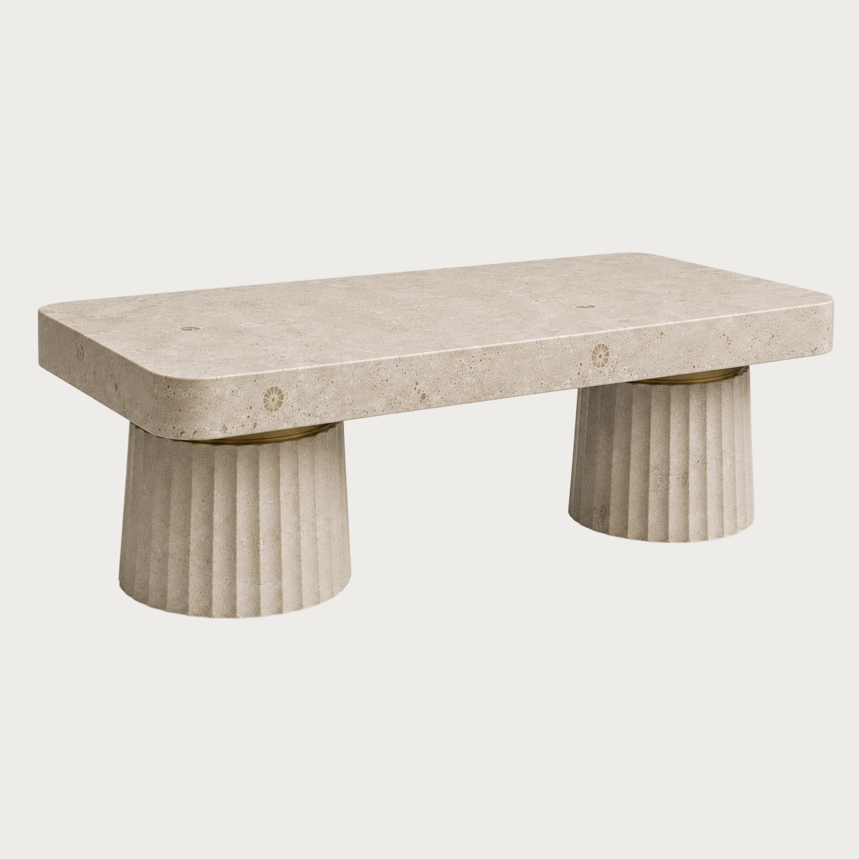 A modern stone kitchen island with a rectangular travertine top and two fluted cylindrical pedestal legs.