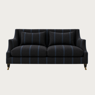 House of Ellory Clarington Sofa upholstered in charcoal grey pinstripe fabric with blue stripes, tailored cushions and traditional caster legs.