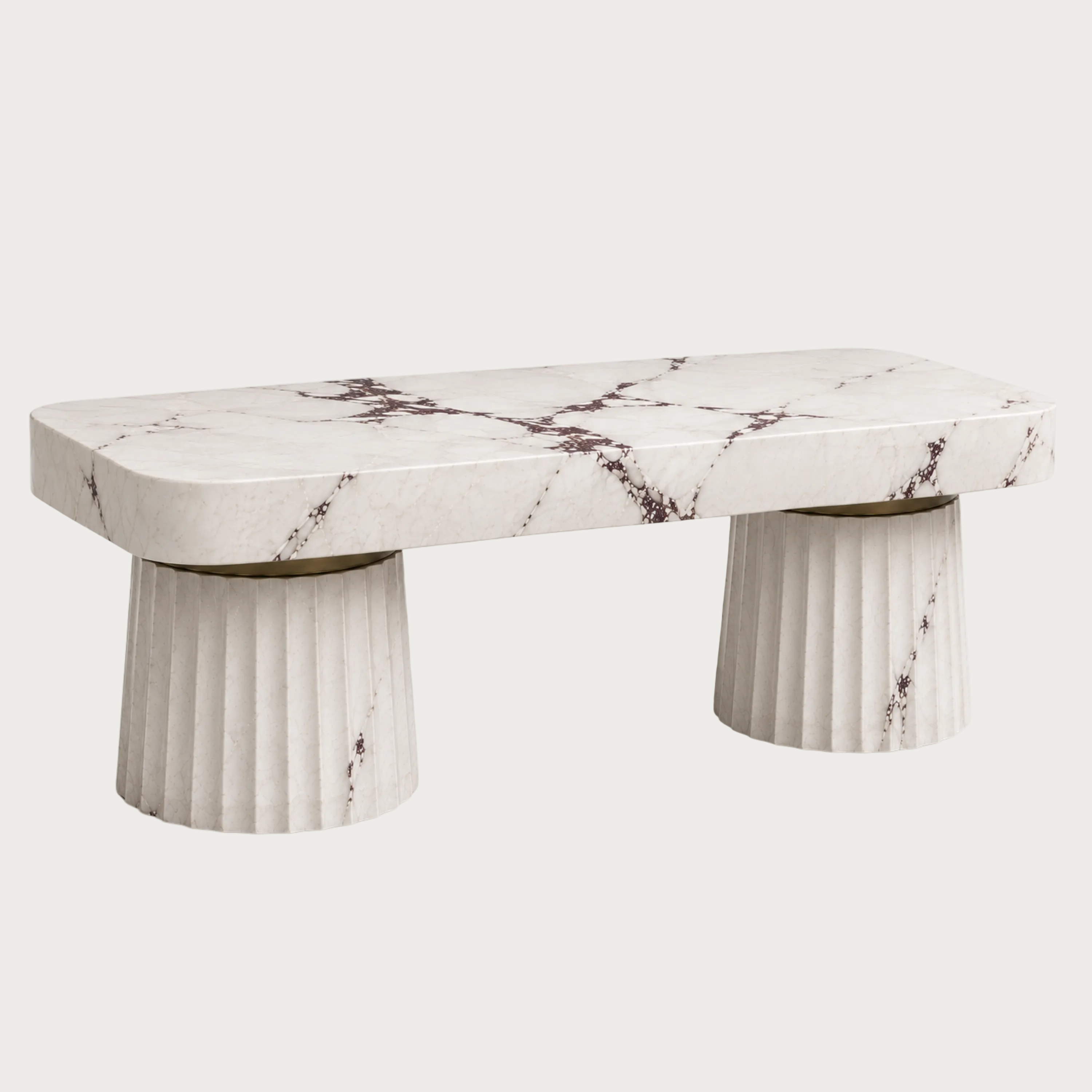A kitchen island with a white marble top featuring dark brown veining and fluted cylindrical legs.