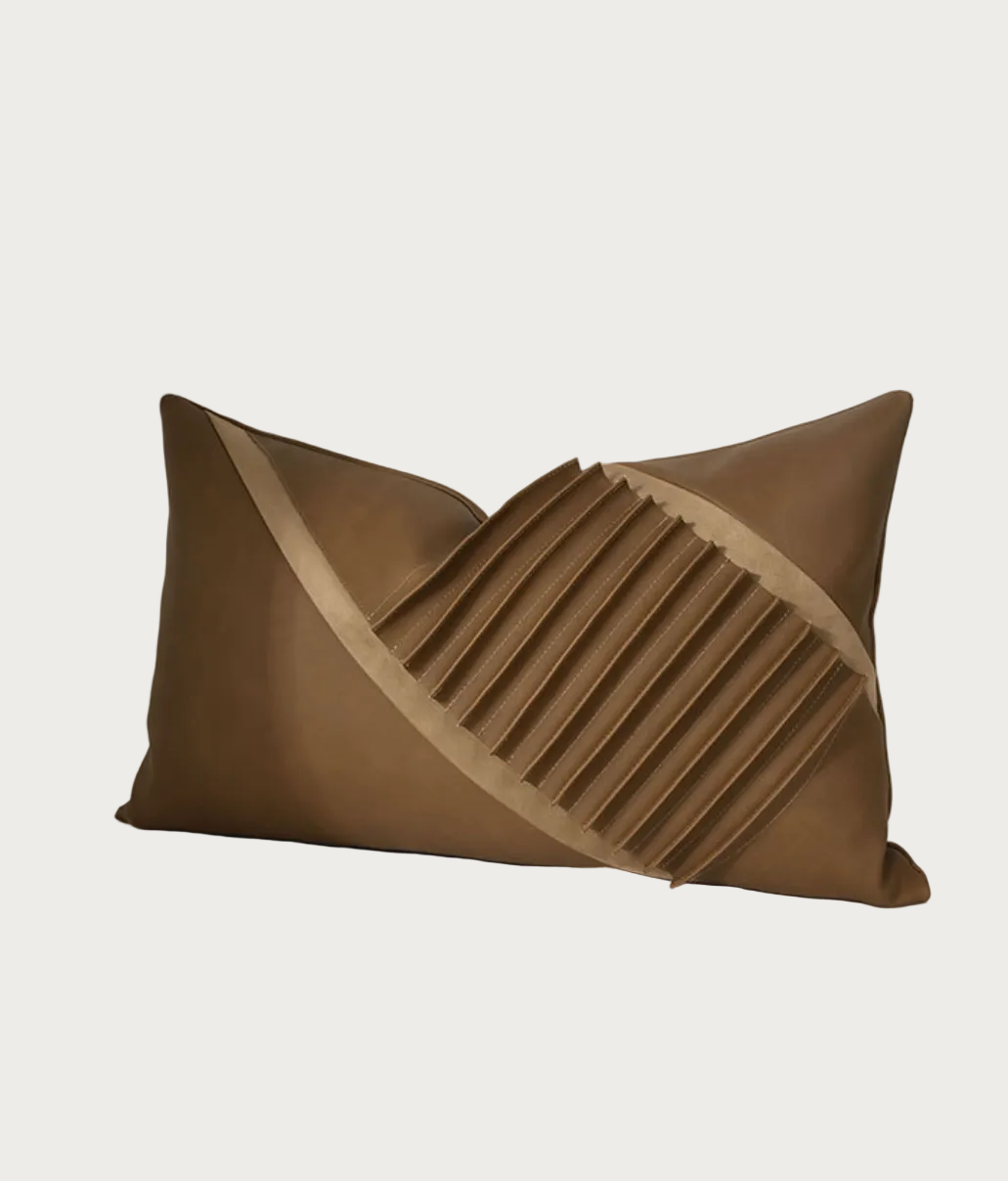 A modern rectangular throw pillow in a warm taupe-brown color, featuring a diagonal pleated geometric design that creates a V-shape and a smooth diagonal accent stripe.