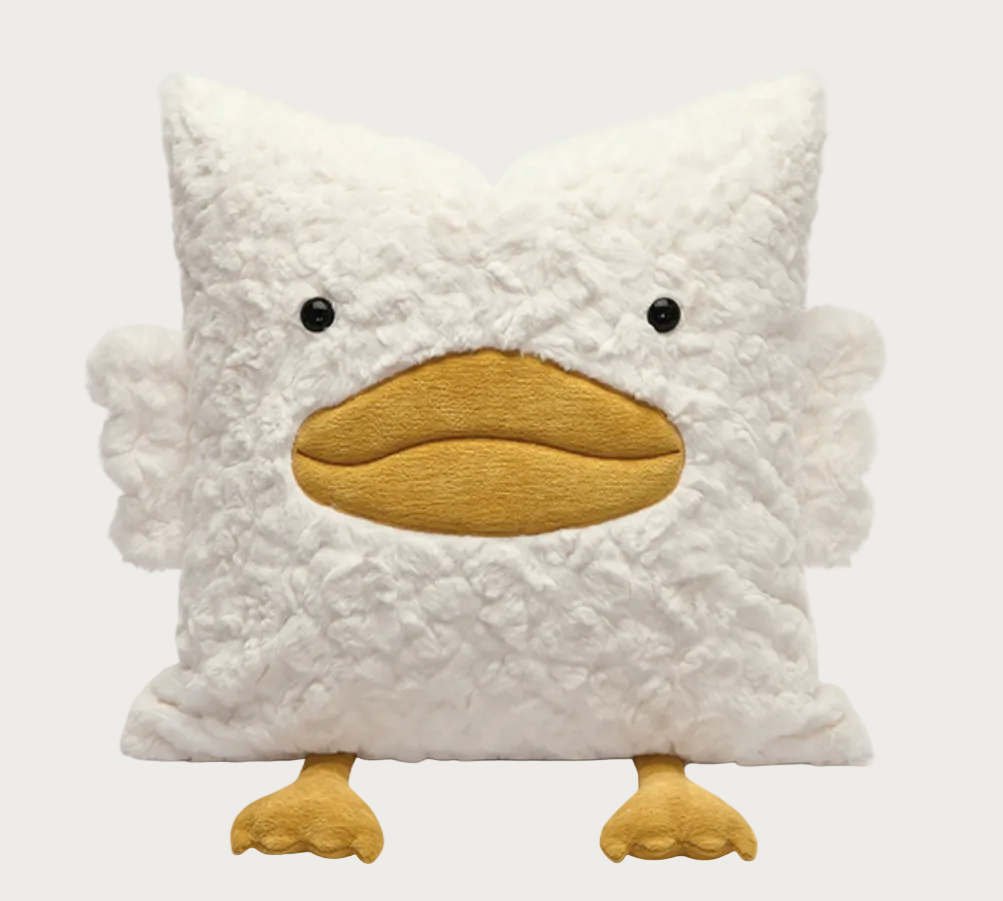 A plush decorative pillow shaped like a duckling, featuring a textured white fluffy body, a mustard yellow beak, small black bead eyes, and two small yellow feet, shown against a plain white background.