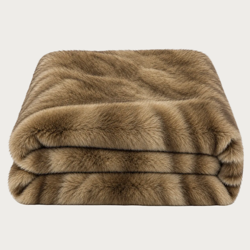 A folded faux fur throw blanket in a warm brown and tan colorway, shown against a plain white background.